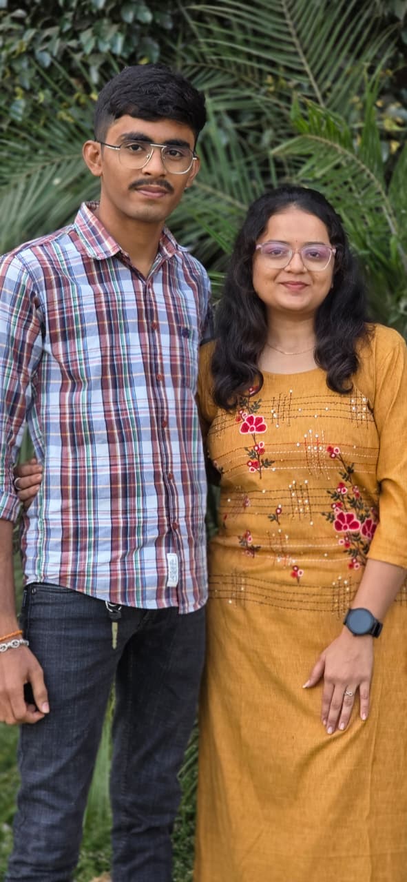 The two of us, close, both looking straight at the camera.